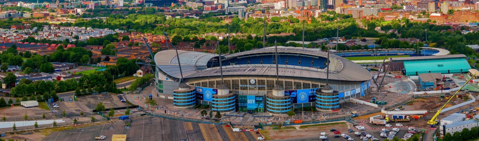 aerial shot if MCFC arena surrounded by trees and buildings