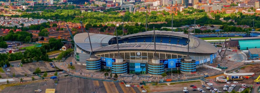 aerial shot if MCFC arena surrounded by trees and buildings