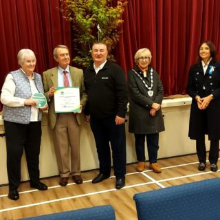 Mr Paul Ashman, Community Engagement Manager for idverde, presents idverde plaque to Elaine and Paul Bancroft who are proactive villagers in Urchfont.  They are watched by Dr Olivia Chapple OBE EMH, High Sheriff of Wiltshire, and Cllr Bridget Wayman, Chairman of Wiltshire Council.