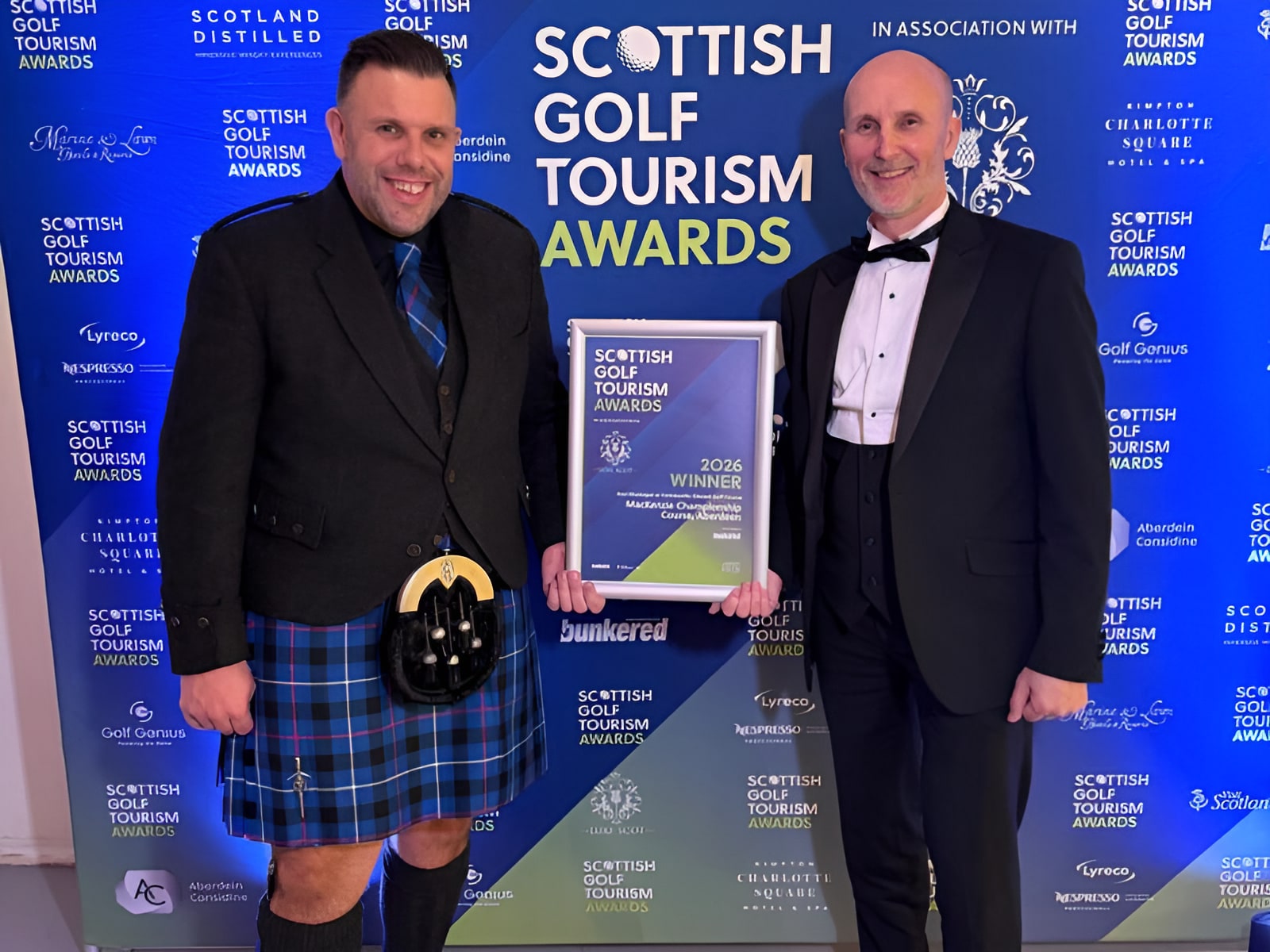 Two men holding Scottish Golf Tourism Awards 2026 Winner certificate for MacKenzie Championship Course, Aberdeen