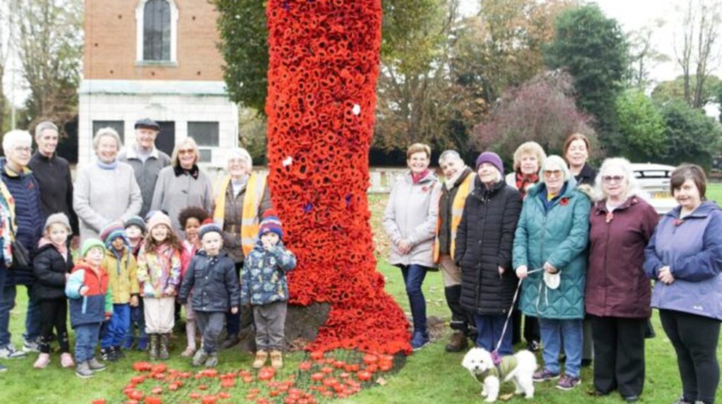 Community group gathers around poppy-covered tree for Remembrance Sunday in Loughborough