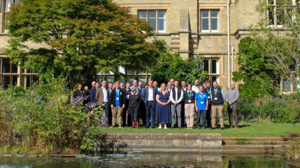idverde UK team gathered outdoors in front of a historic stone building