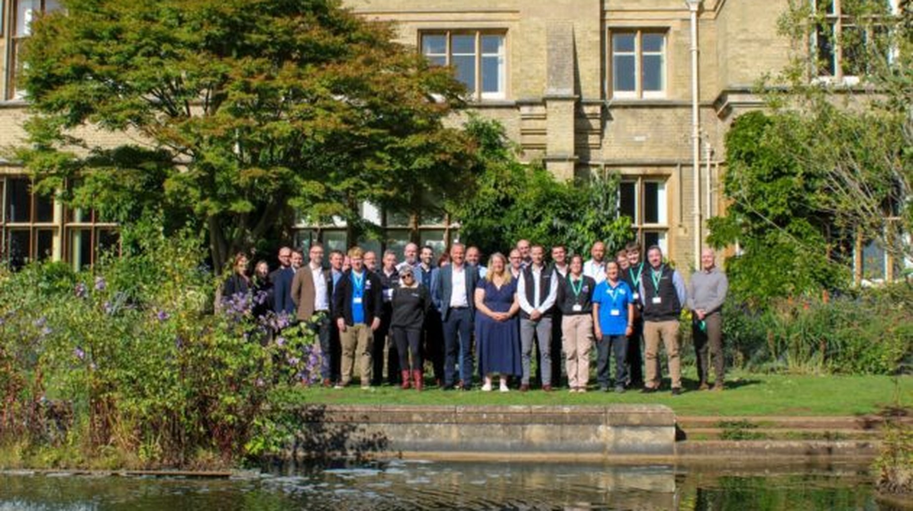 idverde UK team gathered outdoors in front of a historic stone building